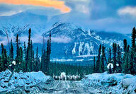 A road cut through the wintery wilderness of Yukon, Canada.