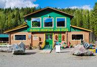 Front of Northern BC roadside store with two large jade boulders.