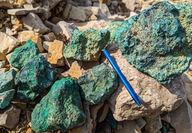 A collection of boulders stained green from their copper content.