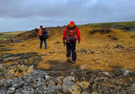 Geologists traverse a highly mineralized outcrop at the Muskox project.
