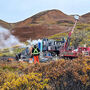 A drill rig tests a gold project on an autumn day in Alaska.