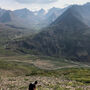 Cantex geologist stands on steep slope overlooking Yukon mountains.