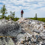 Li-FT geologist standing atop pegmatite outcrop at Yellowknife Lithium project.