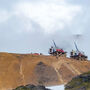 Helicopter atop ridge next to drill rigs testing the Ellis gold zone in Alaska.