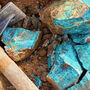 Hammer placed beside highly copper mineralized rock samples.