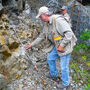 Webb and Malahoff sample a vertical rock face at the Mon gold mine project.