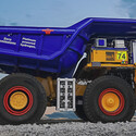 Large mining truck with “zero emissions platinum powered hydrogen” on bed.