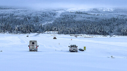 Trucks parked on the frozen Liard River at the Prairie Creek Mine road crossing.