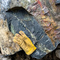 Leather glove provides size context for copper mineralized rock at NICO.
