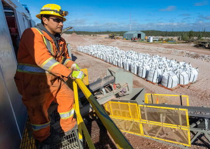A Nechalacho ore sorter operator looks over bags of rare earths concentrates.
