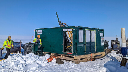 A drill tests for high-grade copper on a flat snow-covered expanse in Nunavut.