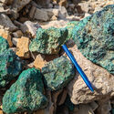 A collection of boulders stained green from their copper content.