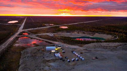 Aerial photo of the sunset on the horizon overlooking the Pine Point mining camp
