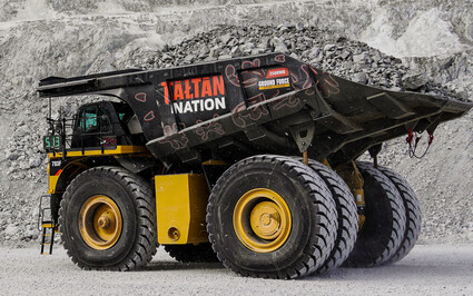 Loaded mining haul truck with a bed painted to honor the Tahltan Nation.