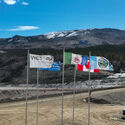 Five flags blow in the wind at Victoria Gold’s Eagle Mine in the Yukon.