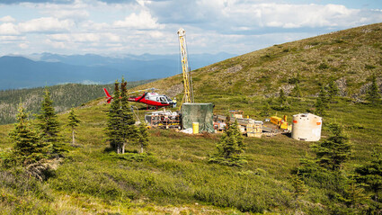 Drill tests for gold on mountain saddle during a summer day in Alaska.