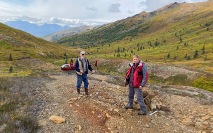 Curt Freeman, Rick Van Nieuwenhuyse at a mineralized outcrop at Sun in Alaska.