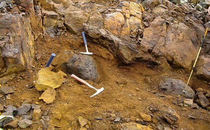 Rock hammers show scale of orange-stained nickel-cobalt-PGE mineralization.