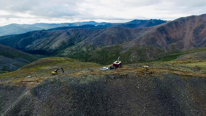 Drone picture of drilling on a mountain ridge at RC Gold project.