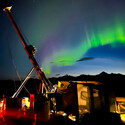 Big Dipper and aurora in sky above a drill testing for critical minerals.