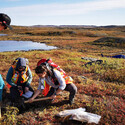 Geologists collect a soil and rock sample below the tundra in Nunavut.