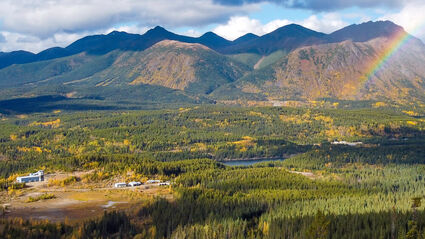 Rainbow touches down during a fall day at the Cassiar gold project in Canada.