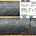 Close up of drill core with a large chunk of visible gold.