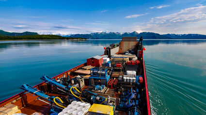 Barge drills mineral exploration equipment Johnson Tract gold deposit Alaska