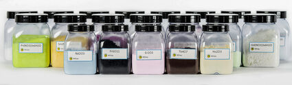 Jars of rare earth element oxides produced by REEtec.
