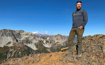 HighGold CEO and geologist Darwin Green on an Alaska mountain ridge.