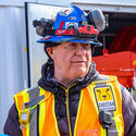 Nechalacho mine manager wearing safety gear answers questions.