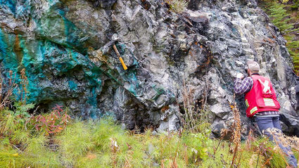 A geologist investigates a copper-stained outcrop in BC’s Golden Triangle.