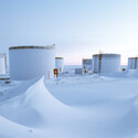 Giant fuel tanks in the snowy landscape of Alaska.