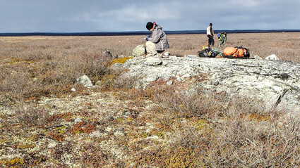 North Arrow team examining possible lithium outcrop.