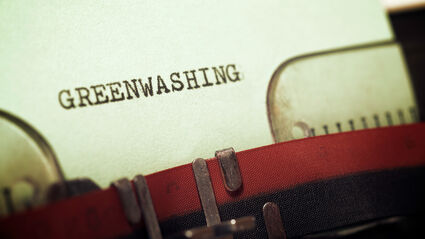 A stylized adobestock picture of the word greenwashing on paper in a typewriter.