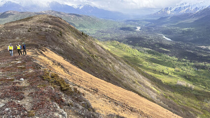 U.S. GoldMining geologists on a ridge at the Whistler project in Alaska.