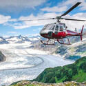 Helicopter flying over a glacial valley in Alaska.