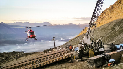 Helicopter approaches a drill testing the mineral-rich Arctic deposit in Alaska.