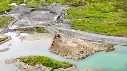 Dozer pushes dirt into pond that stored tailings at Johnny Mountain Mine.