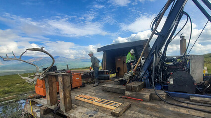 Two drillers test a nickel deposit on a warm late summer day in Alaska.