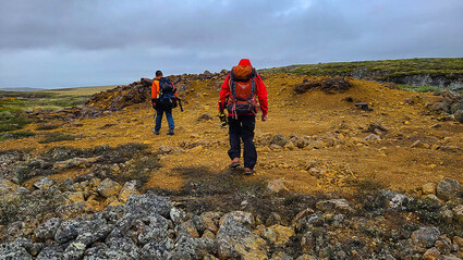 Geologists traverse a highly mineralized outcrop at the Muskox project.