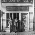 Two women posing for a photo in front of Jeff Smith’s Parlor.