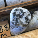 Closeup of core with black zinc mineralization within white host rock.