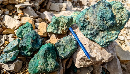 A pile of boulders oxidized green from high-grade copper mineralization.