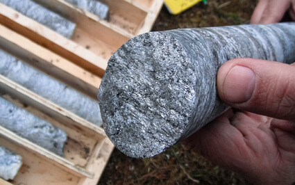 Closeup of silver-colored core from drilling through high-grade graphite.