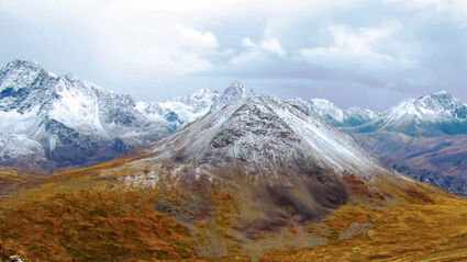 A blanket of snow covers Alaska Range mountains during the fall.