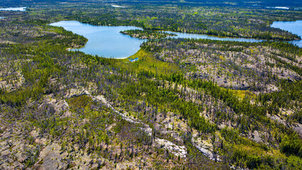 An exposed outcrop surrounded by lakes in NWT, Canada.