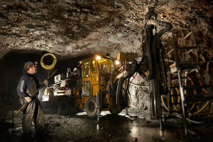 An underground miner and drill at the Greens Creek silver mine in Alaska.