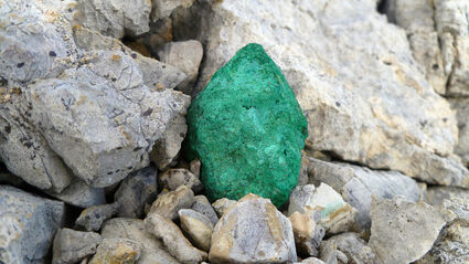 Copper, green from oxidization, lying amongst rocks at the Storm project.