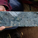 Gunmetal grey core with large nickel-rich sulfide minerals.